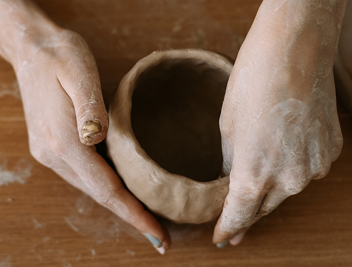 student creating a pot